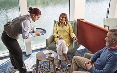 A couple being served drinks int he Lorelei Lounge on the Upper Deck of Spirit of the Rhine